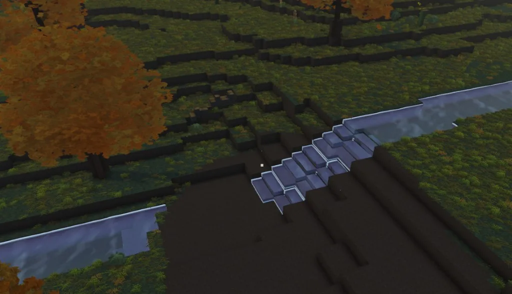 A river cutting downhill through voxel terrain between two stretches of water